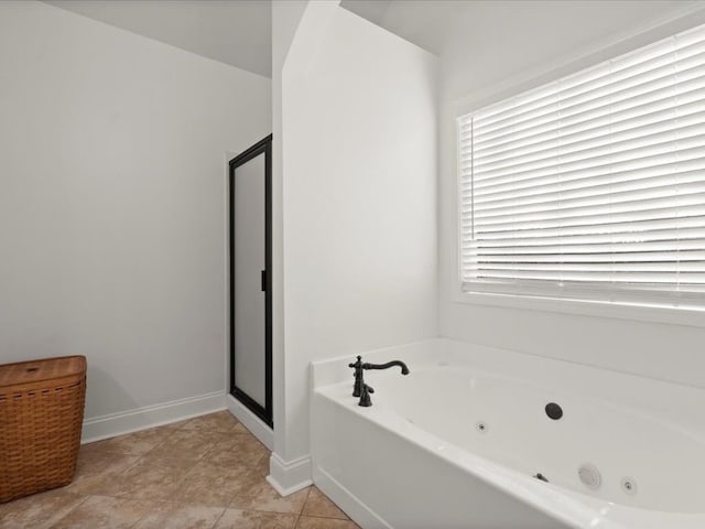 bathroom with tile patterned floors and a tub