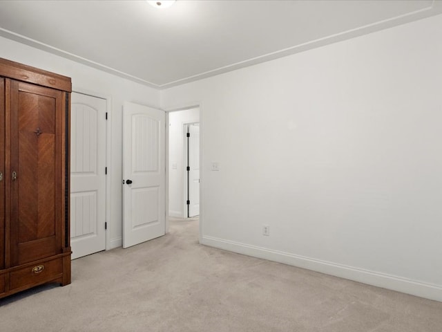 unfurnished bedroom featuring light carpet