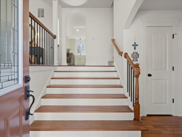 stairway with hardwood / wood-style floors