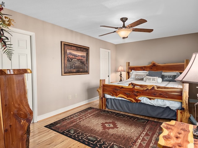 bedroom with light wood-type flooring and ceiling fan