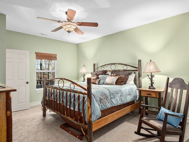 carpeted bedroom featuring a textured ceiling and ceiling fan