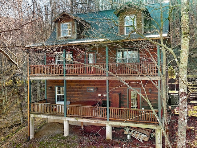 rear view of property featuring a balcony