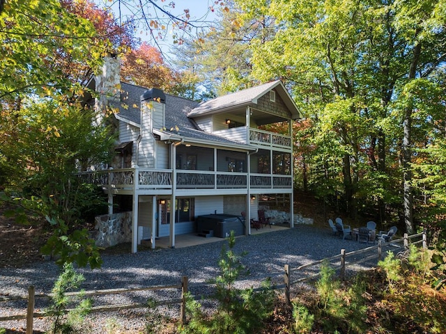 rear view of house featuring a balcony and a patio area