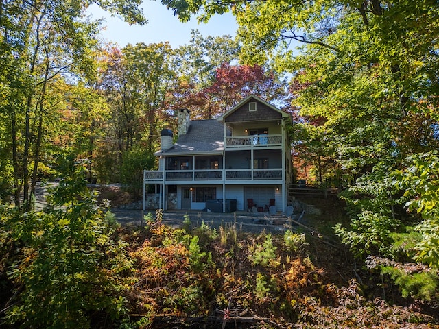 back of property featuring a balcony