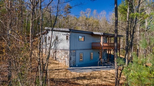 exterior space with driveway and a forest view