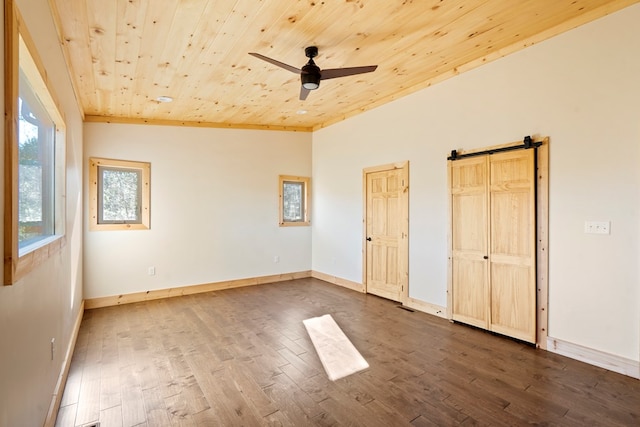 unfurnished bedroom with dark wood-style flooring, a ceiling fan, wood ceiling, vaulted ceiling, and baseboards