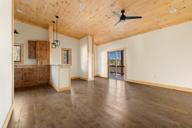 empty room with dark wood-type flooring, wood ceiling, ceiling fan, and baseboards