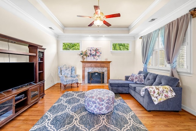 226 Euharlee Five Forks Rd, Kingston, GA 30145 - living room featuring a ceiling fan, a fireplace, a tray ceiling, wood finished floors, and ornamental molding