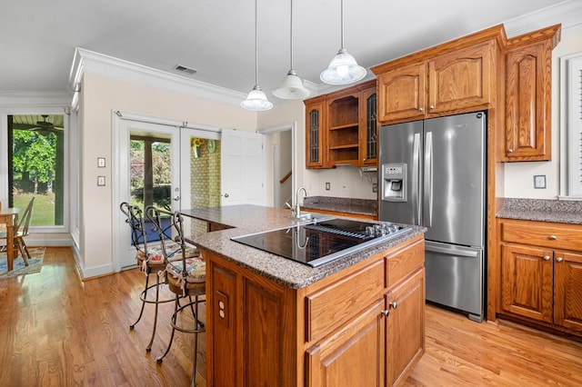 226 Euharlee Five Forks Rd, Kingston, GA 30145 - kitchen with stainless steel fridge with ice dispenser, ornamental molding, black electric cooktop, brown cabinets, and a kitchen bar