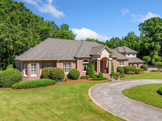 226 Euharlee Five Forks Rd, Kingston, GA 30145 - view of front of home with curved driveway, brick siding, a front yard, and a shingled roof