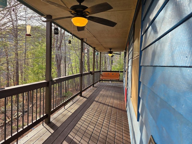 wooden terrace with a ceiling fan