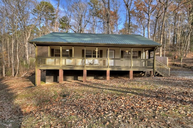 view of front of home featuring covered porch and metal roof