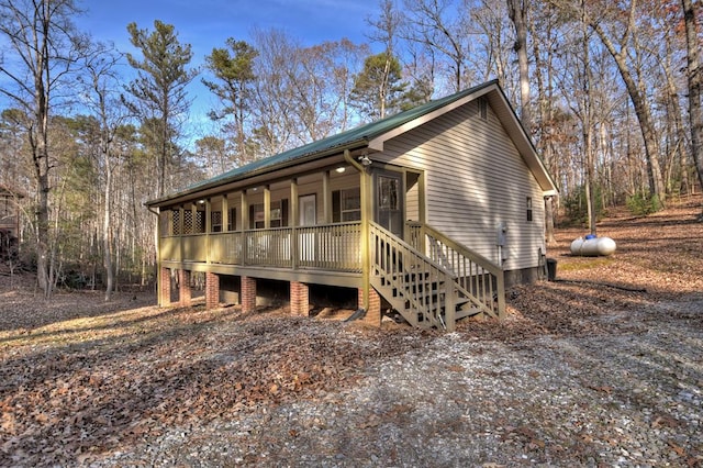 view of front of house with covered porch and metal roof