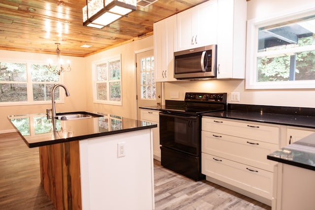 61 Morningside Ct, Ellijay, GA 30540 - kitchen with stainless steel microwave, black range with electric stovetop, wood ceiling, dark countertops, and light wood-style flooring