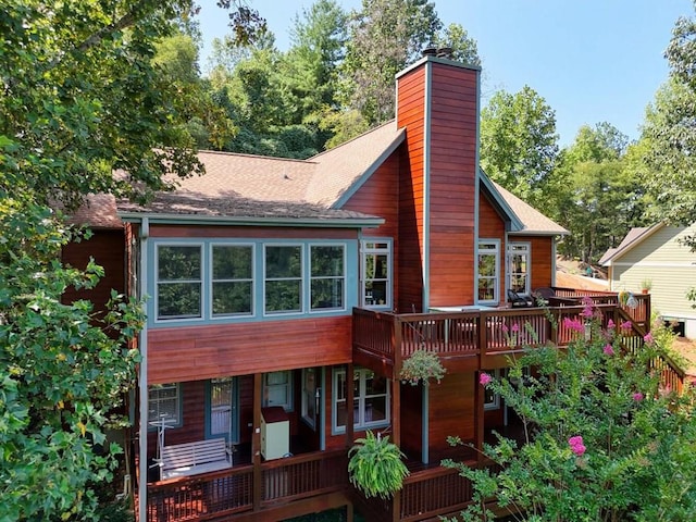 back of house featuring a wooden deck