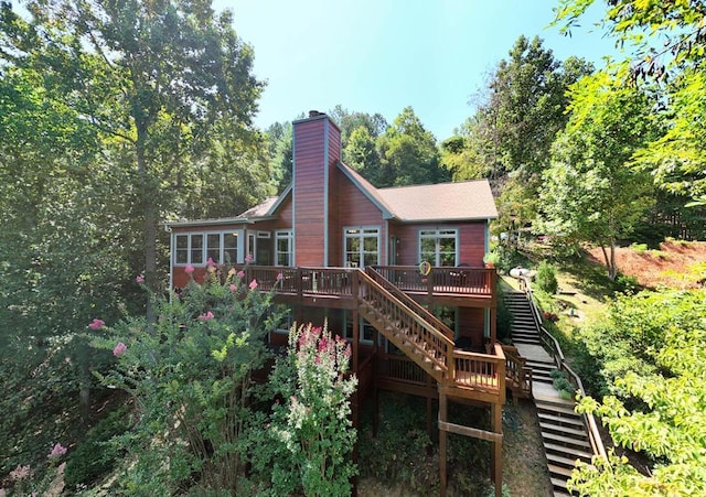 rear view of property with a wooden deck