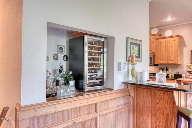 kitchen featuring a kitchen breakfast bar, light brown cabinets, beverage cooler, crown molding, and kitchen peninsula