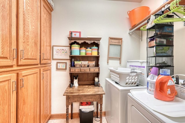 laundry room featuring washer and dryer and cabinets