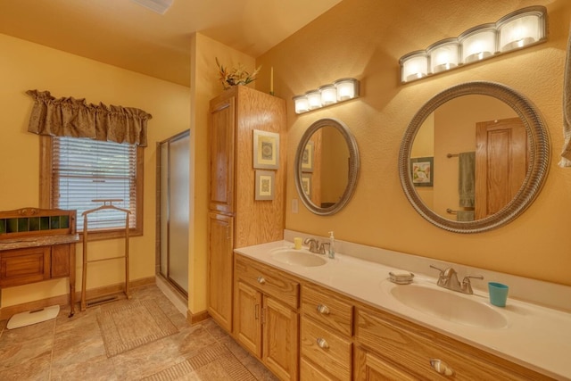 bathroom featuring tile patterned flooring, a shower with door, and vanity