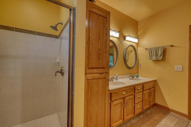 bathroom with an enclosed shower and vanity