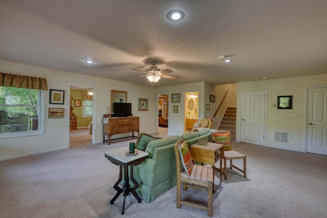 carpeted living room featuring ceiling fan