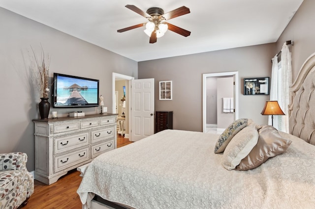 bedroom featuring connected bathroom, light hardwood / wood-style floors, and ceiling fan