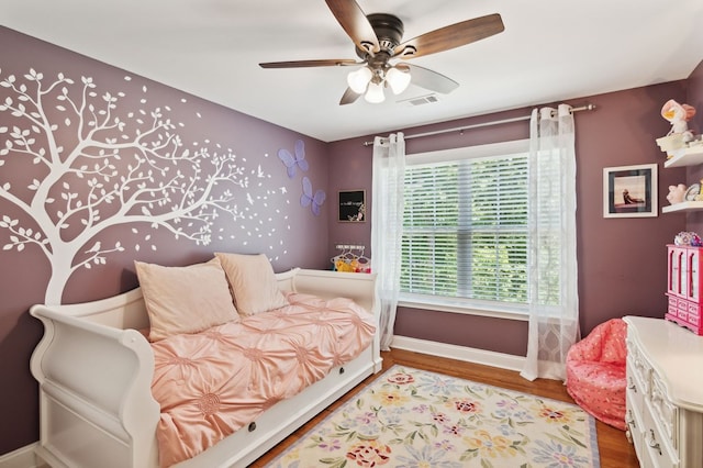 bedroom with hardwood / wood-style flooring and ceiling fan