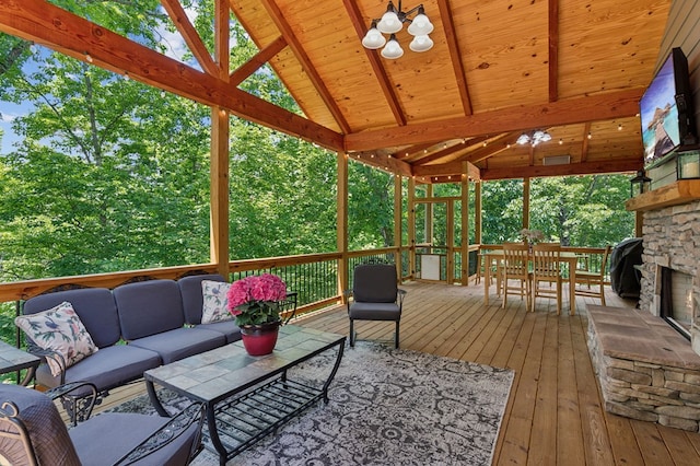 wooden deck with an outdoor living space with a fireplace