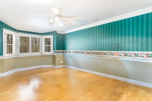 unfurnished room featuring ceiling fan, ornamental molding, and hardwood / wood-style flooring