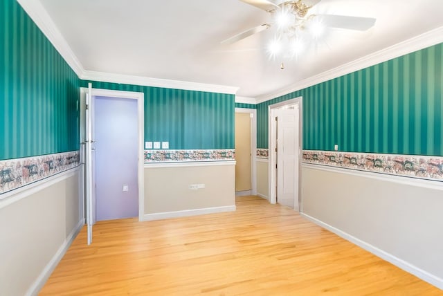 empty room with hardwood / wood-style floors, ceiling fan, and crown molding