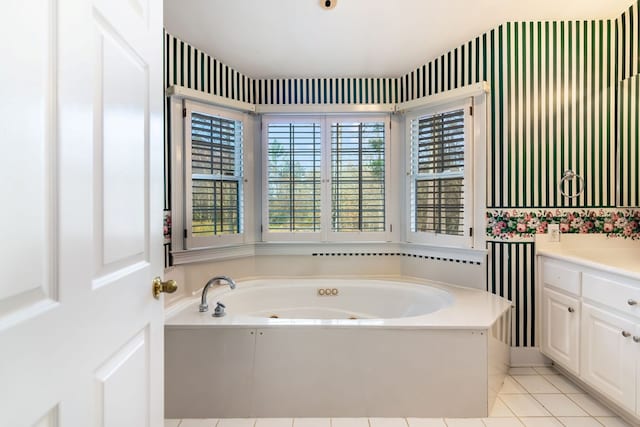 bathroom with tile patterned flooring, vanity, and a washtub