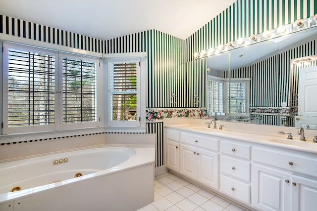 bathroom featuring a bathtub, tile patterned flooring, vanity, and a healthy amount of sunlight