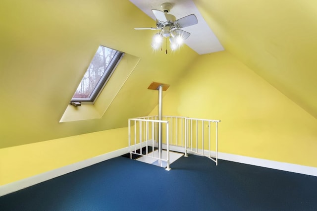 bonus room featuring carpet floors, lofted ceiling with skylight, and ceiling fan