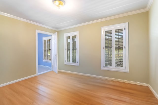 empty room featuring light hardwood / wood-style floors and crown molding