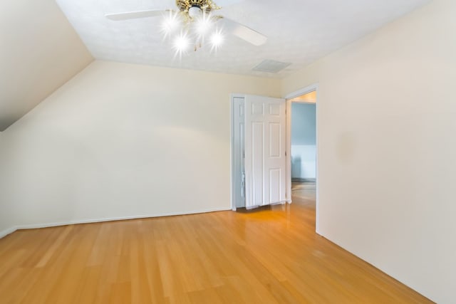 interior space featuring hardwood / wood-style flooring, ceiling fan, lofted ceiling, and a textured ceiling