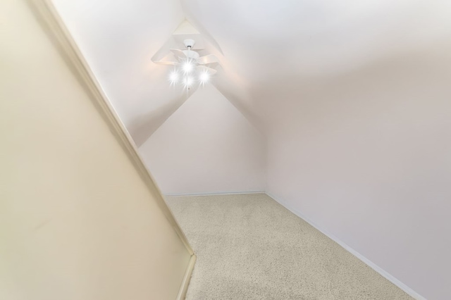 interior space featuring carpet floors and lofted ceiling