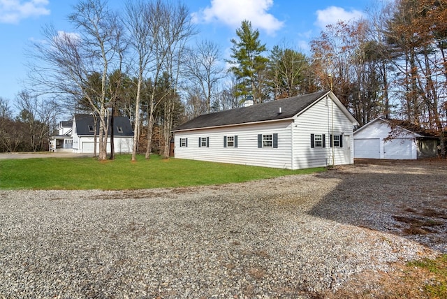 view of home's exterior featuring an outbuilding, a garage, and a lawn