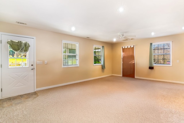 carpeted foyer with ceiling fan and a healthy amount of sunlight