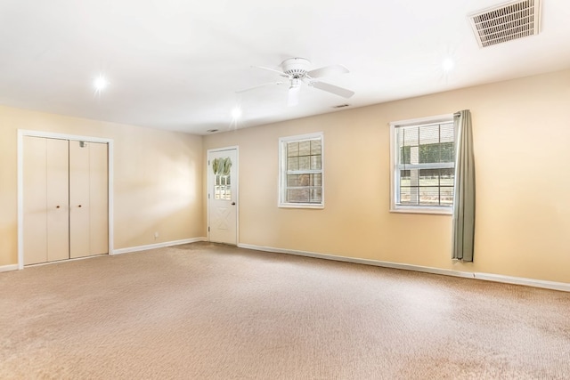 empty room with carpet and ceiling fan