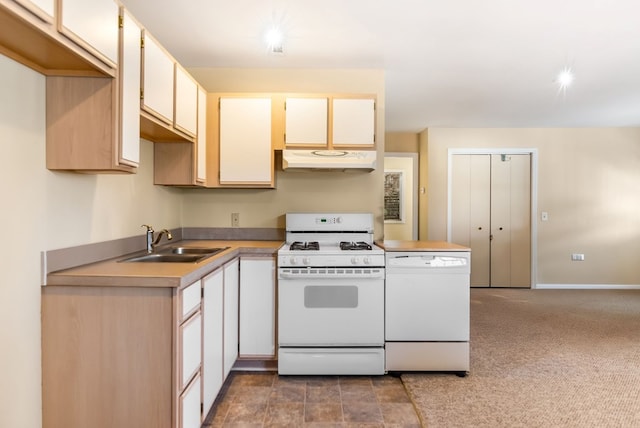 kitchen with carpet flooring, white appliances, and sink