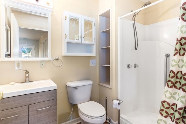 bathroom with toilet, vanity, and a shower with shower curtain