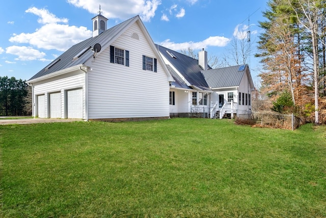 back of property with covered porch, a garage, and a lawn