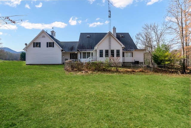 rear view of property featuring a yard