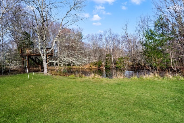 view of yard featuring a deck with water view