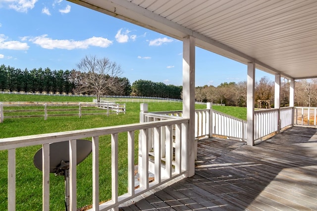 wooden deck with a rural view and a porch