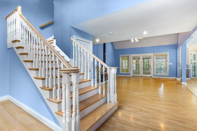 staircase with hardwood / wood-style floors