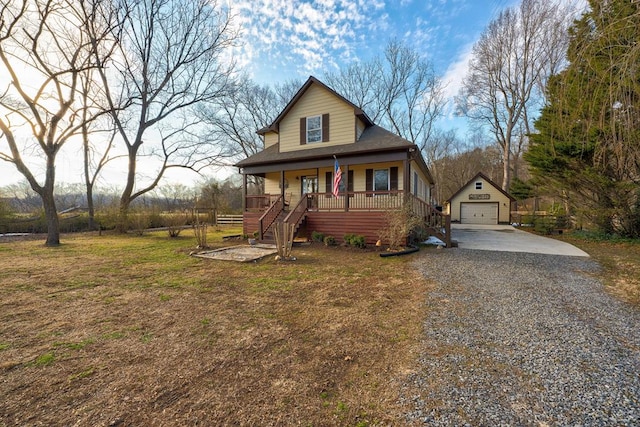 view of front of house with an outbuilding, a front lawn, a porch, and a garage