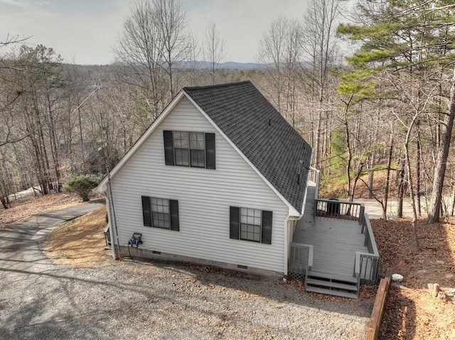 exterior space featuring a shingled roof and crawl space