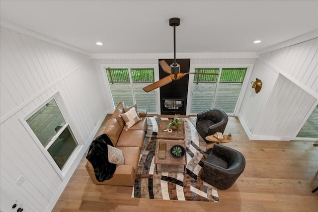 1220 Walnut Rdg, Ellijay, GA 30536 - living room featuring wood finished floors, a ceiling fan, a glass covered fireplace, a decorative wall, and recessed lighting