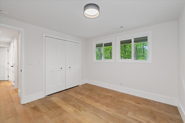 1220 Walnut Rdg, Ellijay, GA 30536 - unfurnished bedroom featuring baseboards, light wood-style flooring, and a closet